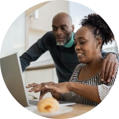 Father and daughter looking at a laptop