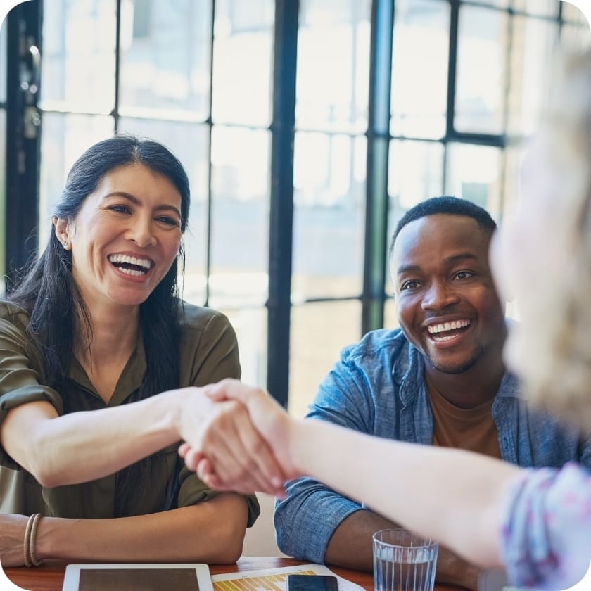 Couple shaking hands with a banker